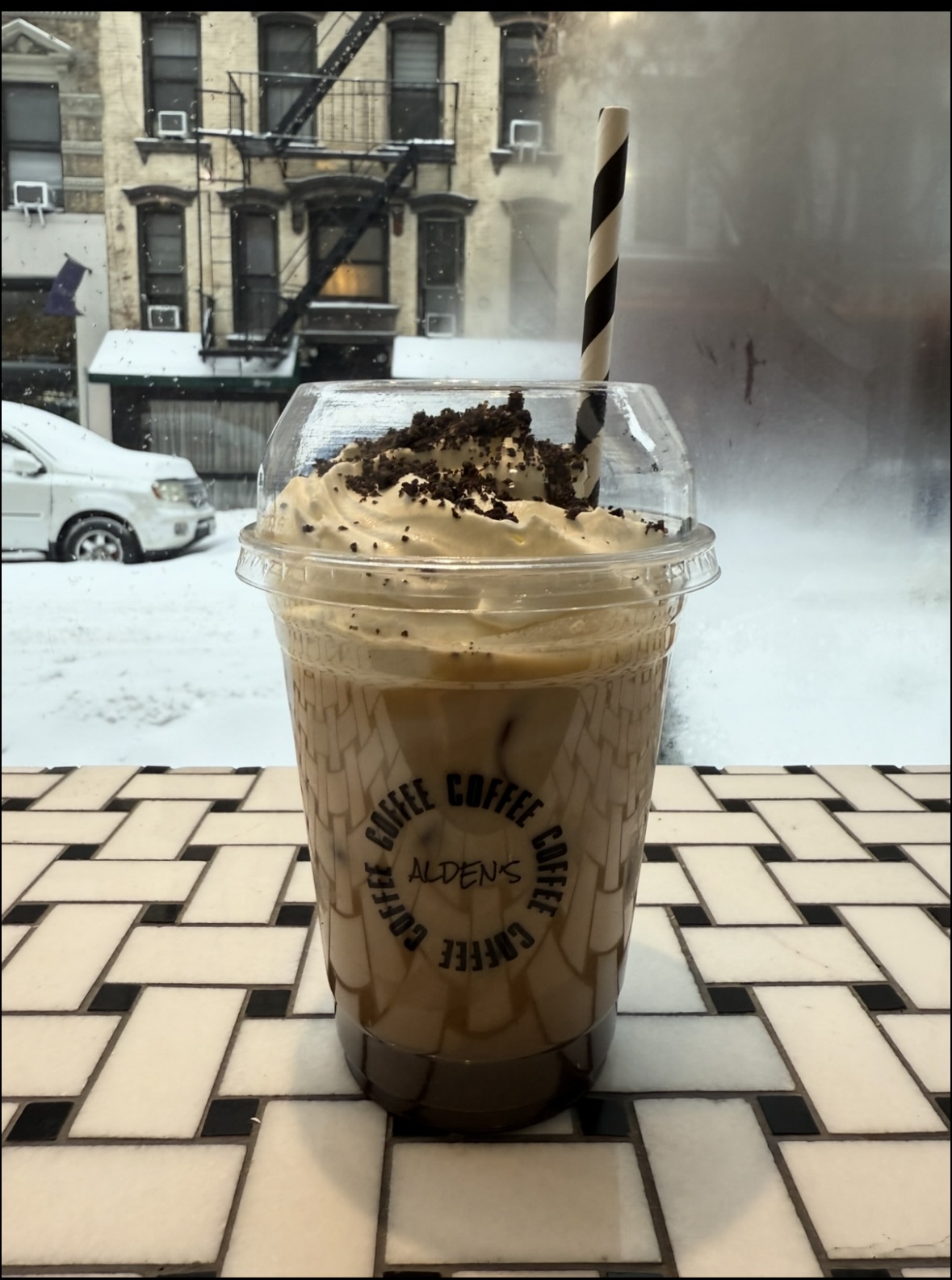 Alden's Oreo Latte topped with cream and cookie crumb