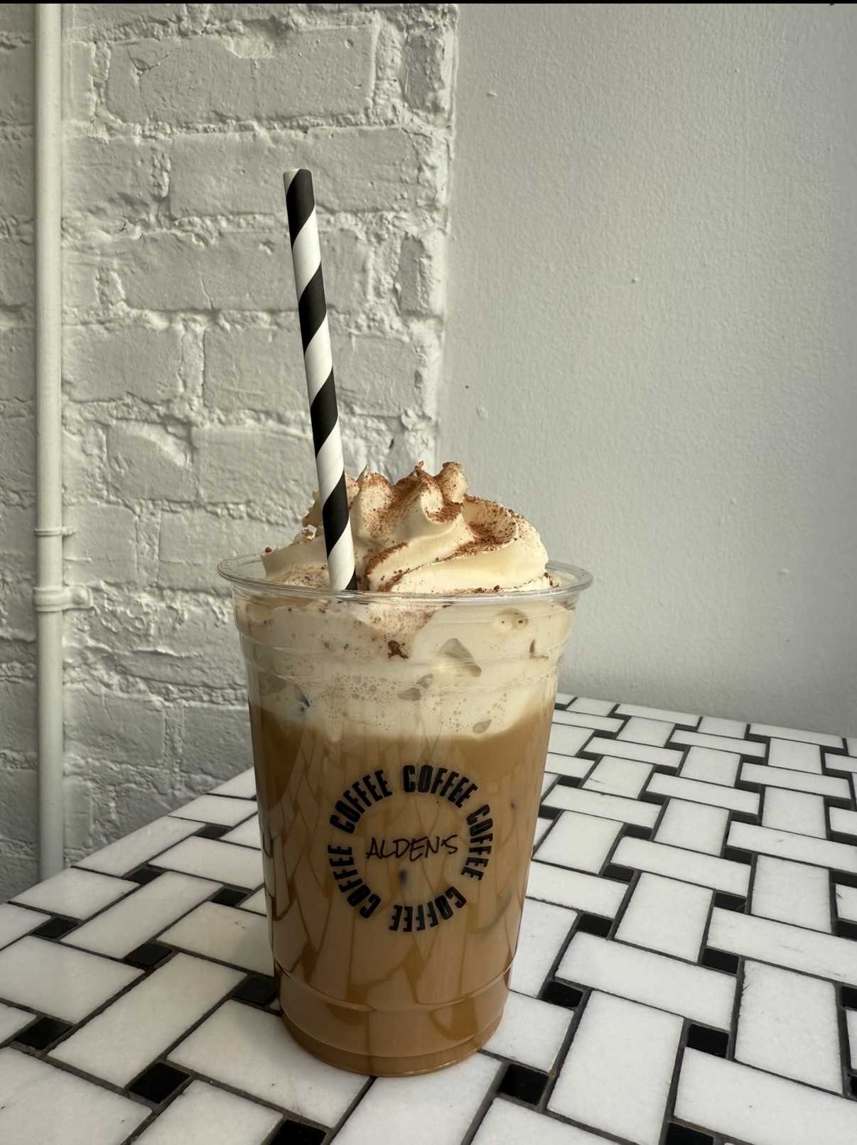 Alden's Tiramisu Latte with cream and cocoa